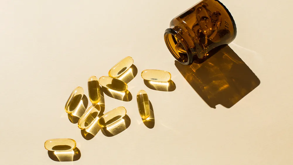 Photo of Omega 3 capsules spilled from a bottle