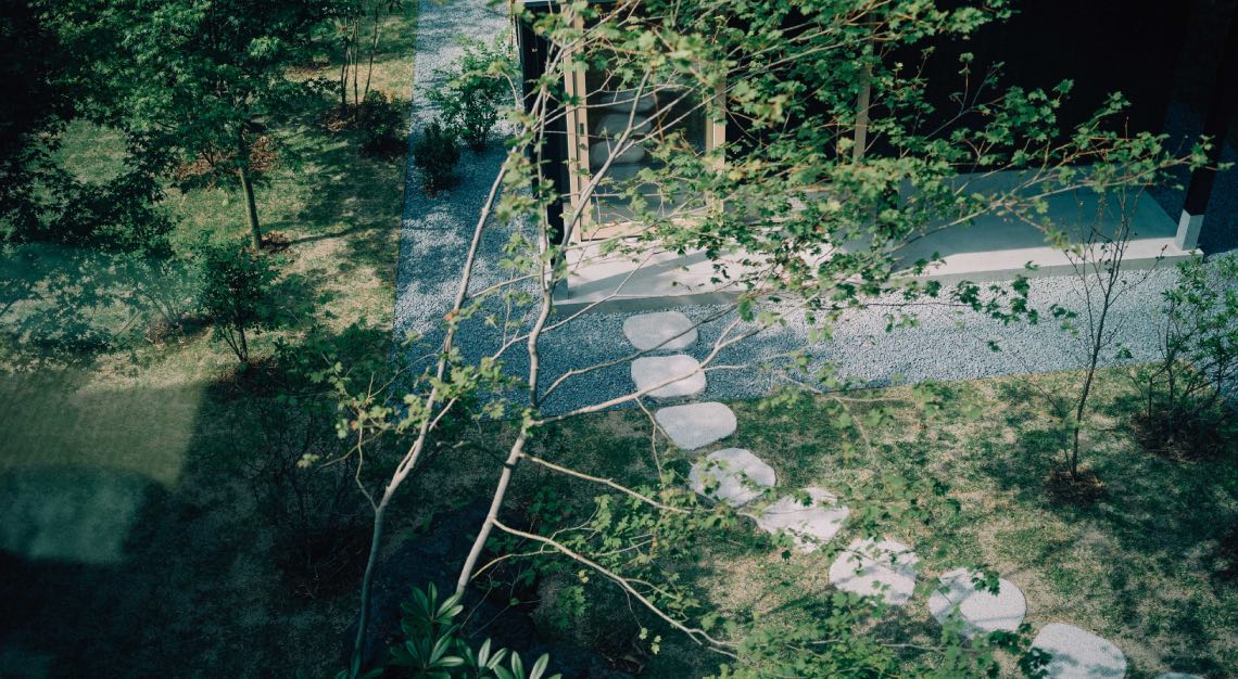 Photo of a garden with a stone walkway