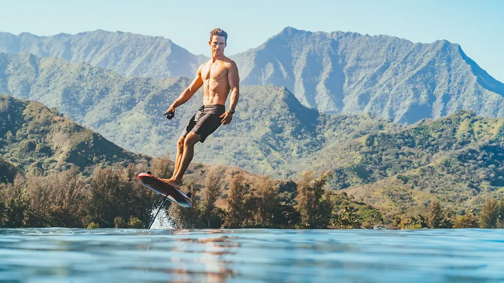 photo of a man surfing on Lift Foils' Lift3 F electric surfboard