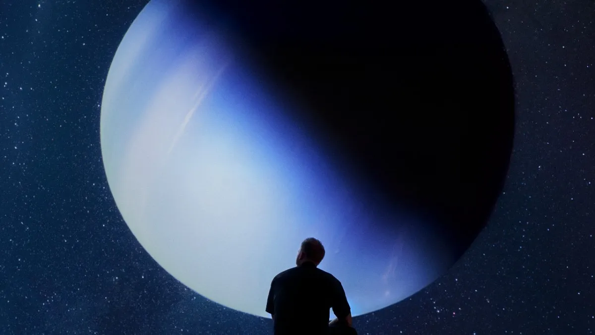 Rasmus Munk's silhouette sat in front of a blue planet