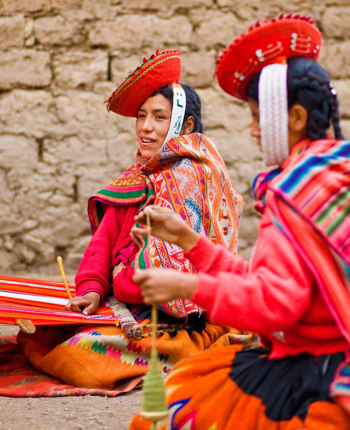 two Peruvian women in colourful garbs