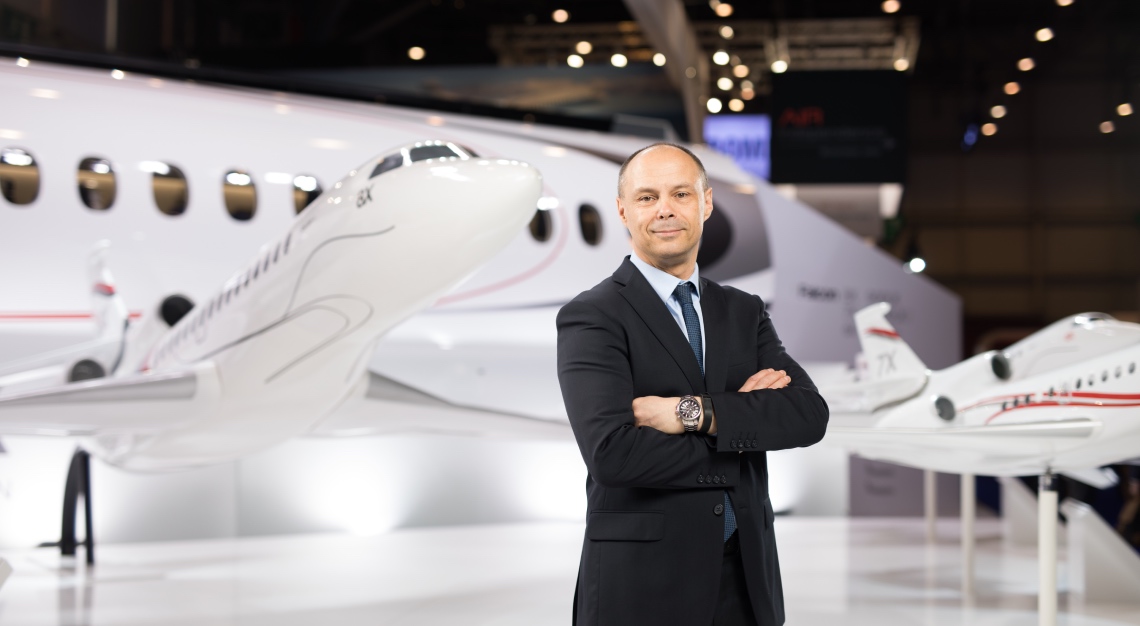 Carlos Brana standing in front of a Dassault aircraft