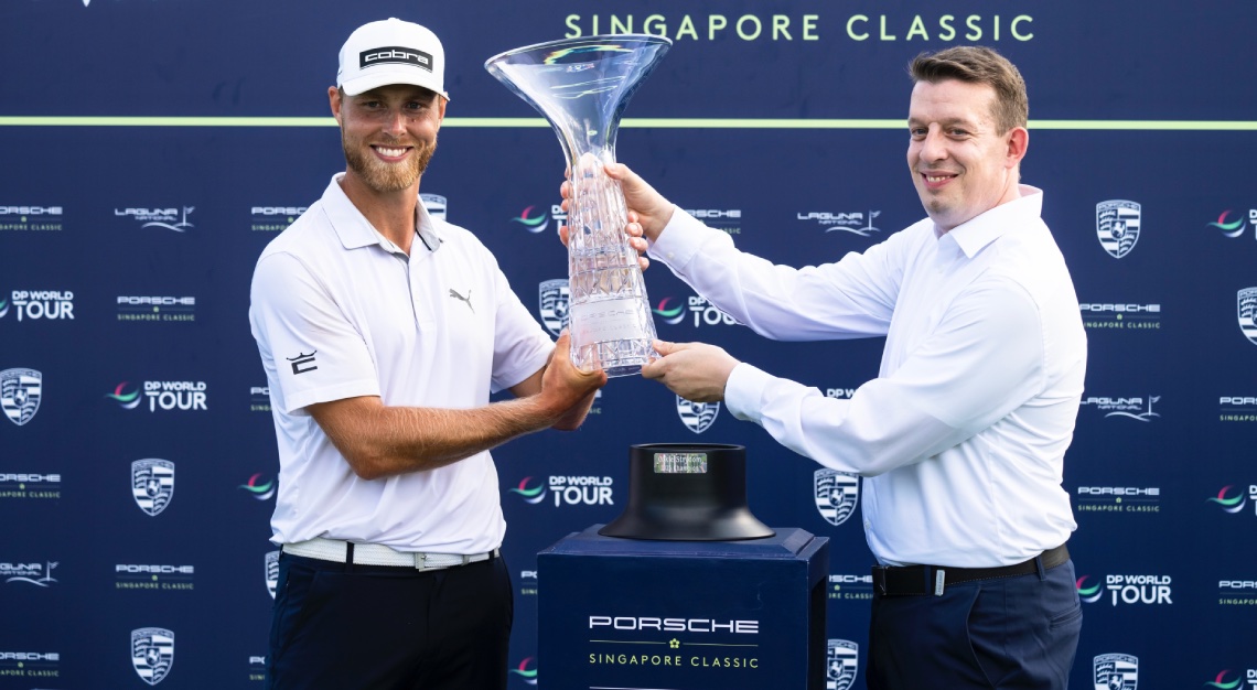 golfer Jesper Svensson lifting the trophy at the Porsche Singapore Classic