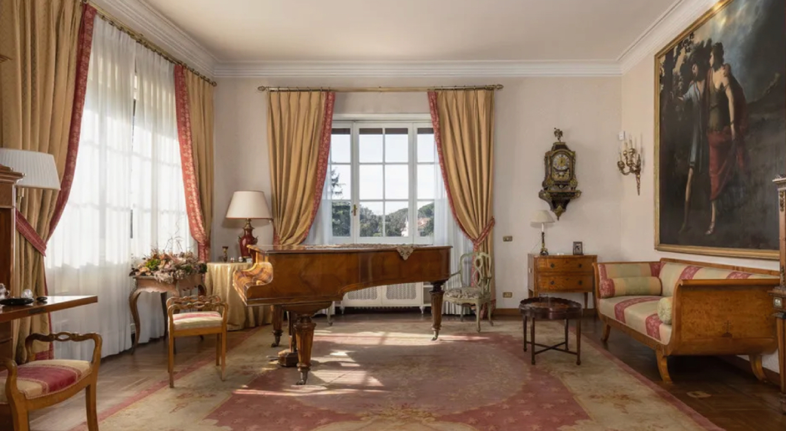 A formal salon with an antique grand piano