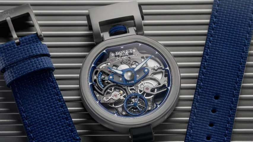 mid shot of the Aperto 1 watch, with two blue straps beside it