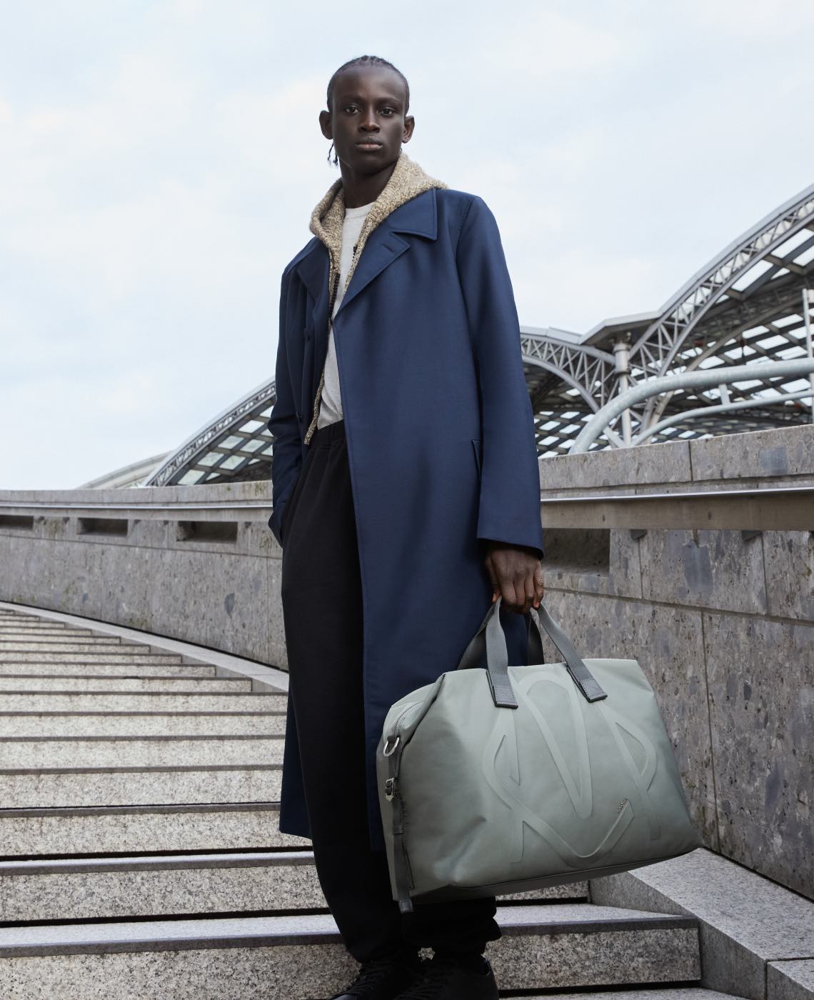 Man carrying a Rimowa Signature Duffle Bag