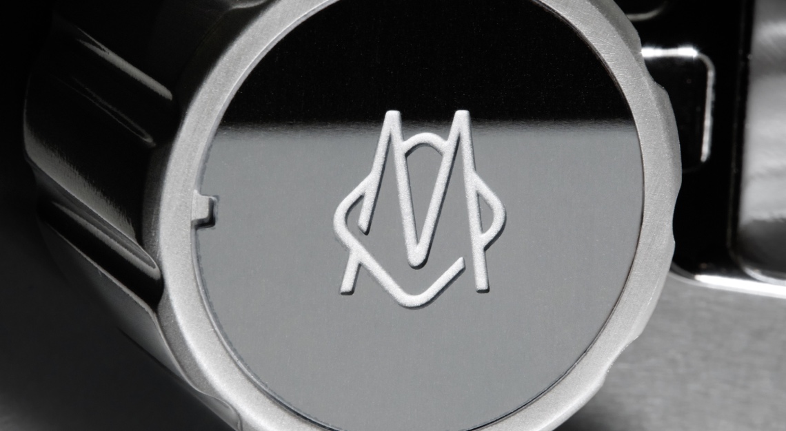 Knob emblazoned with logo on Rimowa and La Marzocco espresso machine