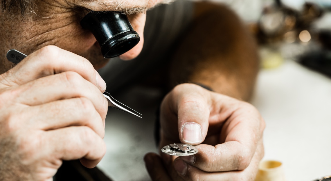 a swiss watchmaker working on a timepiece