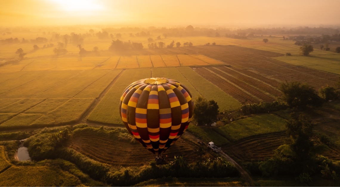 a hot air balloon with a sunrise in the background