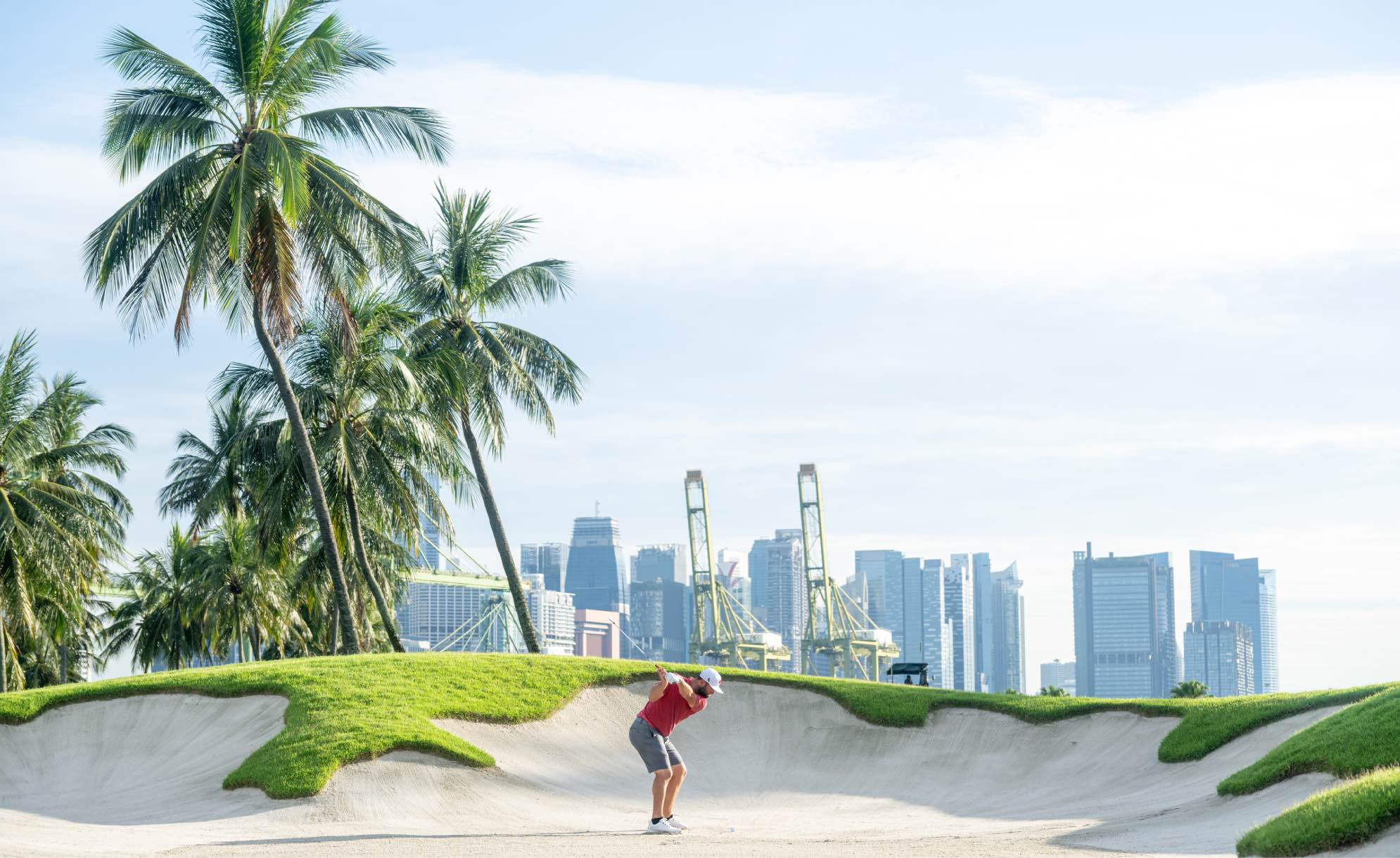 Captain Jon Rahm of Legion XIII GC hits his shot from the fifth bunker during the final round of LIV Golf Singapore at Sentosa Golf Club