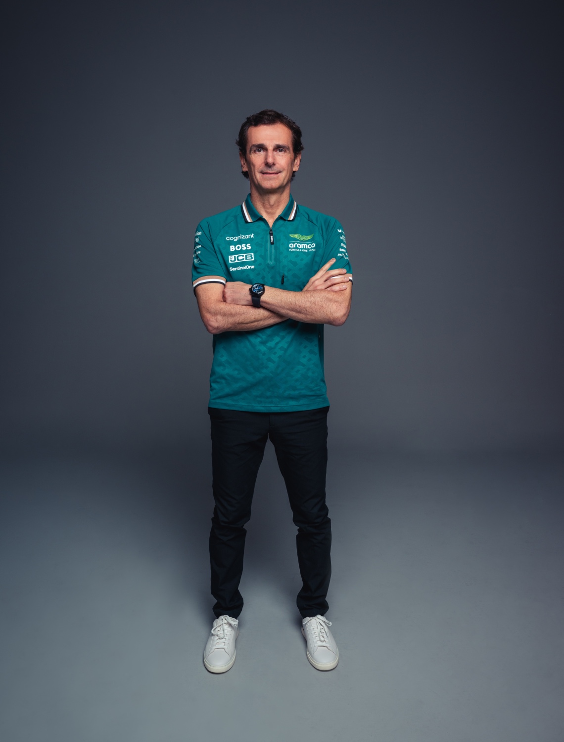 former formula 1 driver pedro de la rosa standing in an empty grey room